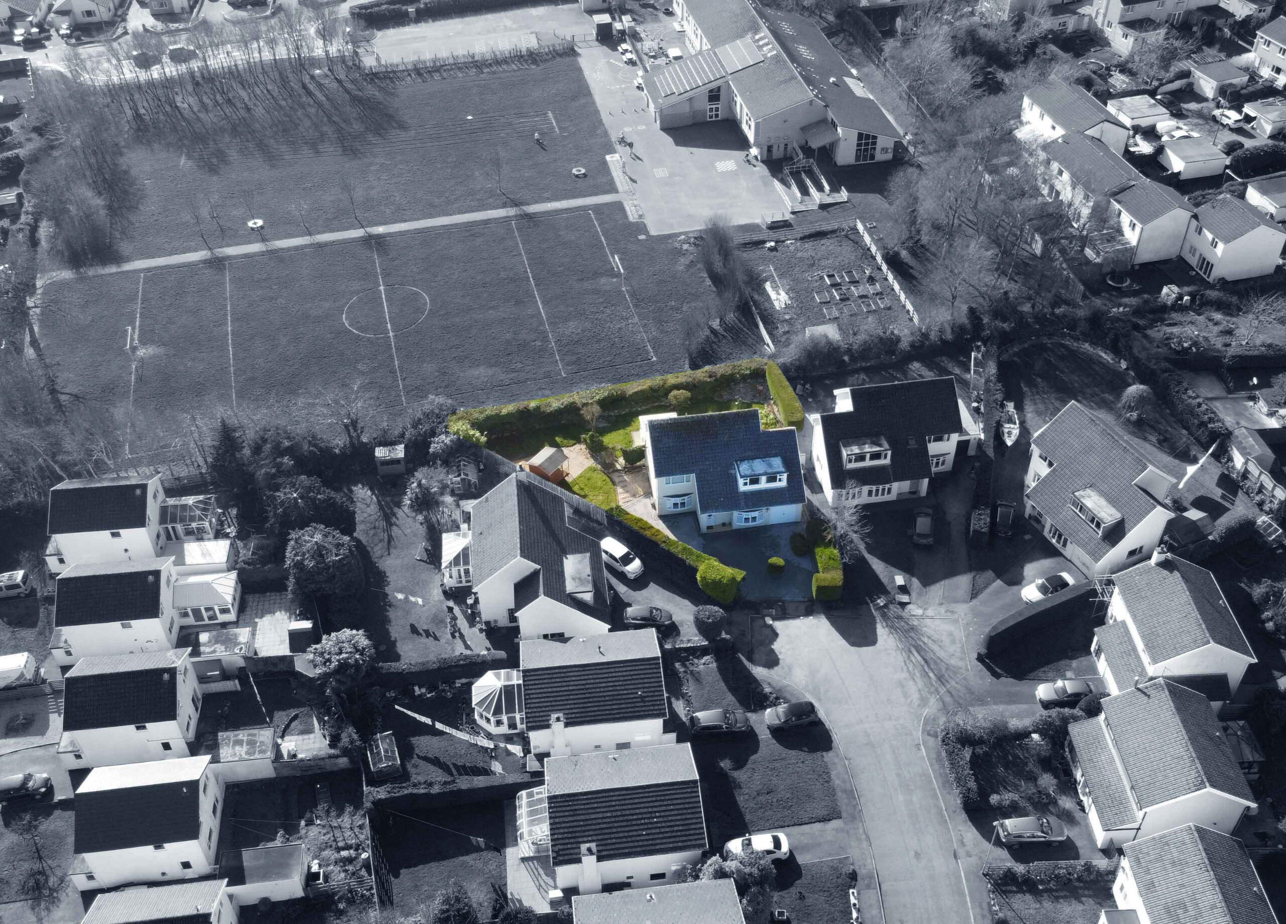 Aerial view of The Mill Bank Retreat holiday home in Llandegfan, Anglesey, North Wales, with private garden, hot tub area, and nearby playing fields.