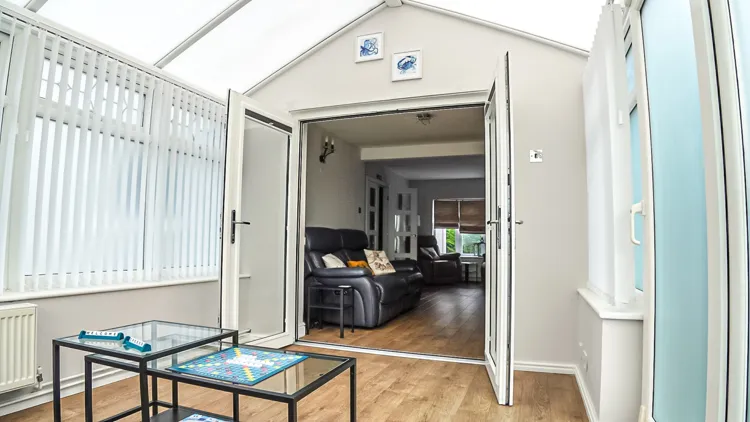 Light-filled conservatory opening into the living room